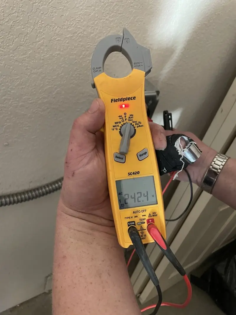 Voltage testing with clamp meter during Whole House Surge Protector in New Albany